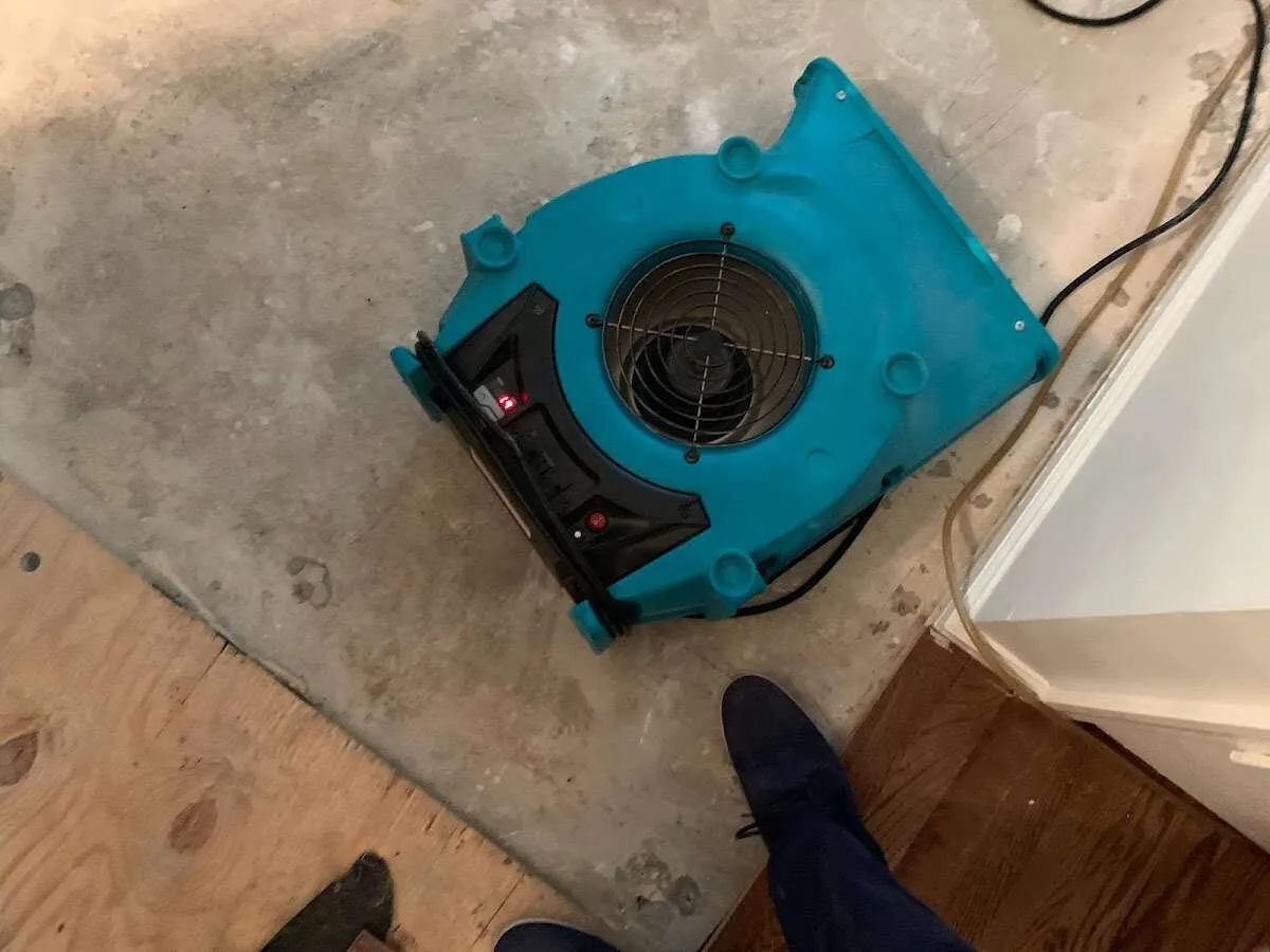 Air mover drying subfloor during Commercial Water Damage Restoration in Casper